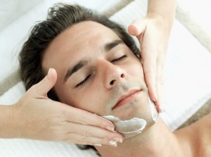 Elevated view of a young man getting a facial